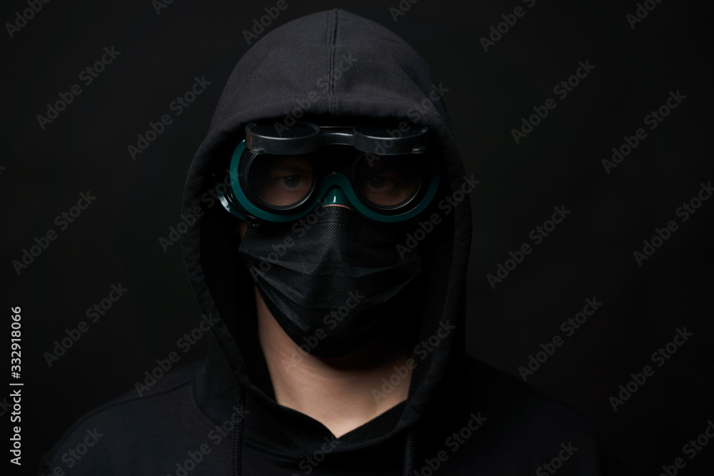 Young man wearing face mask and protective glasses.