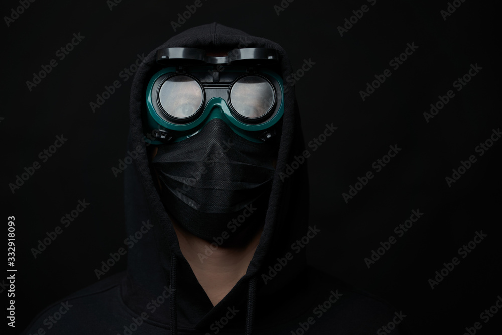 Young man wearing face mask and protective glasses. Young man wearing face mask and protective glasses.