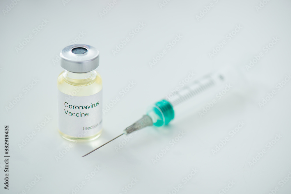 Close-up of syringe and coronovirus vaccine on gray background Pandemic Covid-19 Close-up of syringe and coronovirus vaccine on gray background Pandemic Covid-19