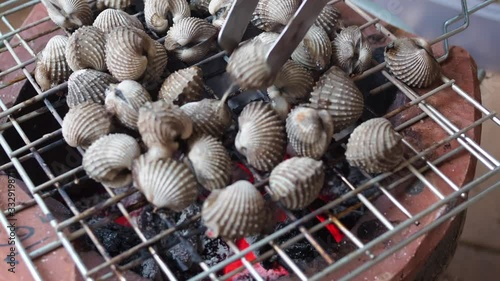 Grilled cockle on a charcoal grill. Holiday and family concept 