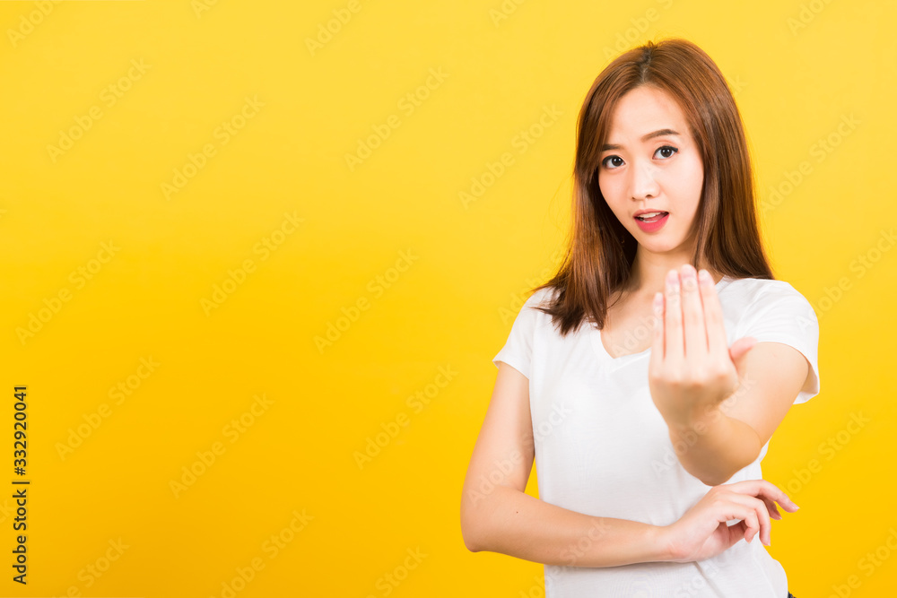 woman teen smile standing wear white t-shirt making gesture hand inviting to come woman teen smile standing wear white t-shirt making gesture hand inviting to come