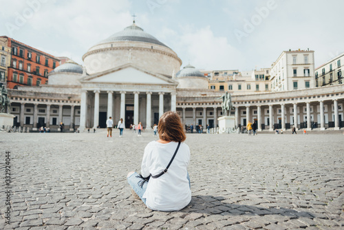 Young woman tourist sitting in the front of Piazza del Plebiscito