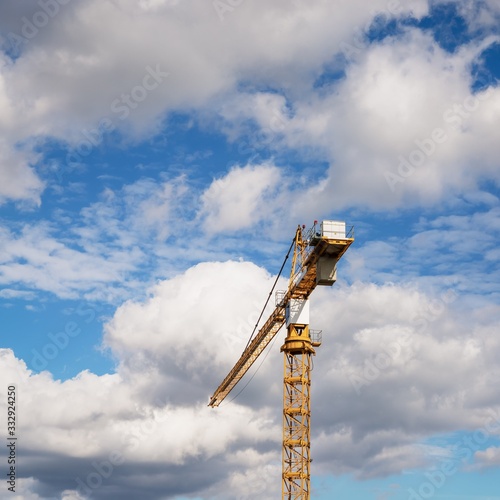 YelloYellow crane and beautiful cloudy sky with white clouds. Details, copy space