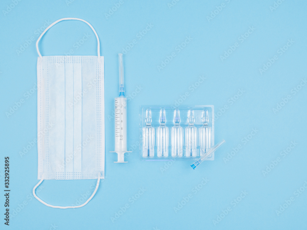 Mask, syringe and ampoule on blue background. Mask, syringe and ampoule on blue background.