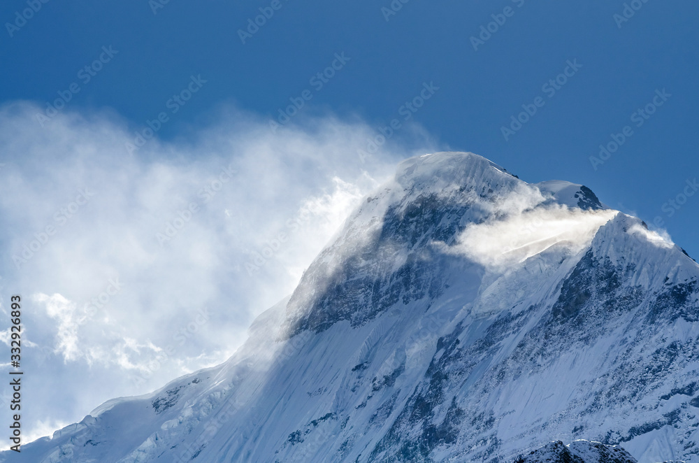 Snow covered Mt. Nilgiri summit in sunny day. Kali Gandaki valley, Annapurna circuit / Jomsom trek, Nepal.