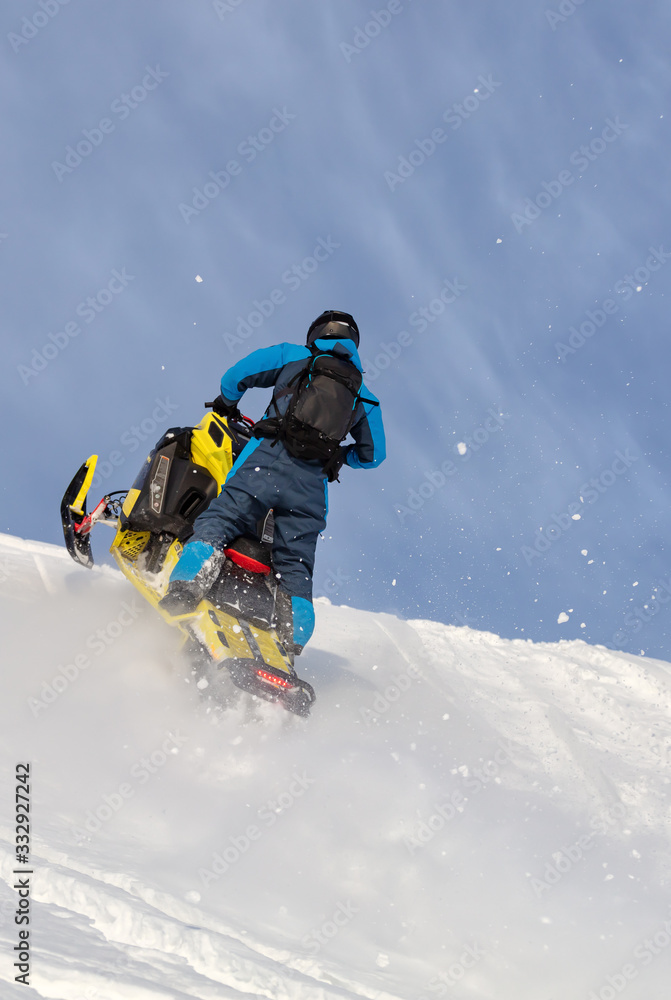 jump on a mountain snowmobile from a high ledge with the descent of a large avalanche. snowmobilers sports riding. Winter extreme. testing of a new model of mountain snowmobile, prototype 2021