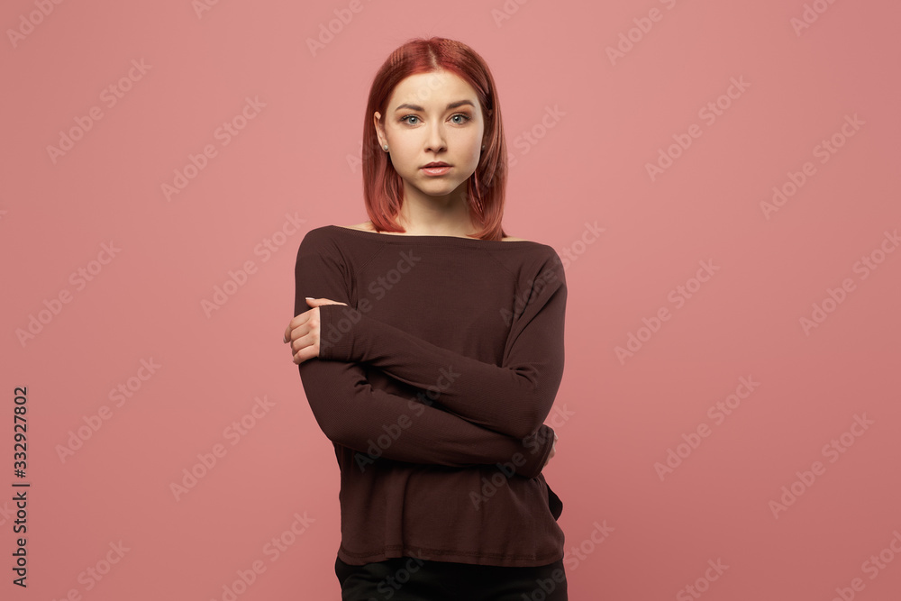 Serious ginger woman with gray eyes in burgundy sweater Serious ginger woman with gray eyes in burgundy sweater