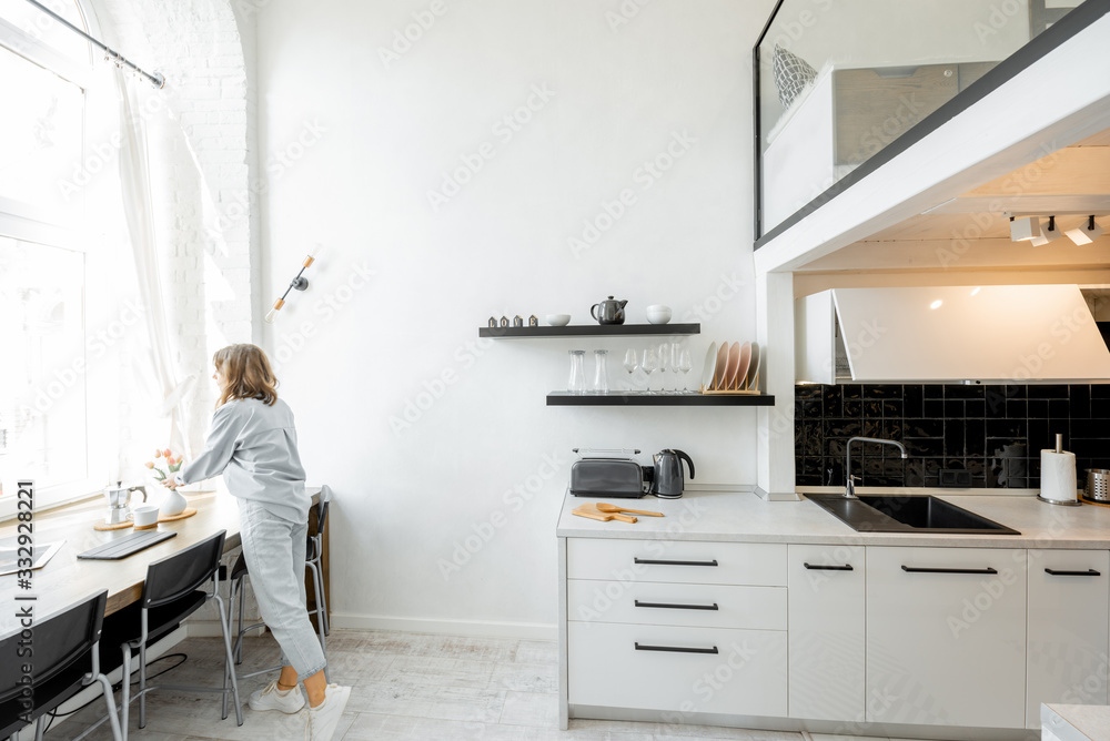 © rh2010 - Interior view of the bright and modern kitchen with a blurred in motion human figure © rh2010 - Interior view of the bright and modern kitchen with a blurred in motion human figure