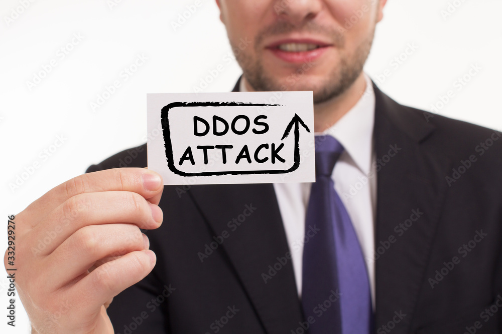 Business, Technology, Internet and network concept. Young businessman working on a virtual screen of the future and sees the inscription: Ddos attack Business, Technology, Internet and network concept. Young businessman working on a virtual screen of the future and sees the inscription: Ddos attack