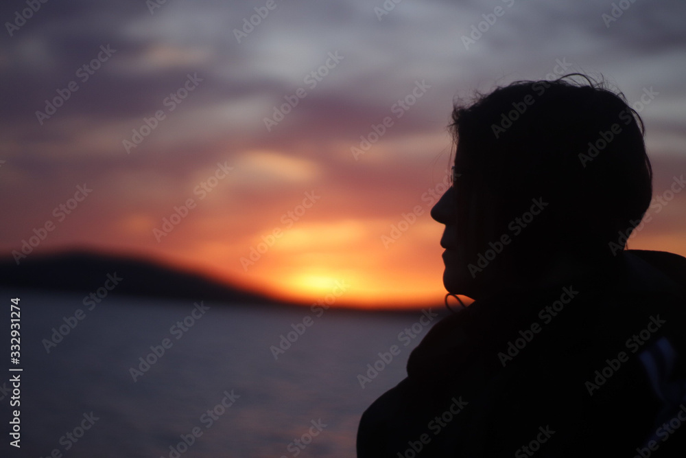 woman looking into sunset 