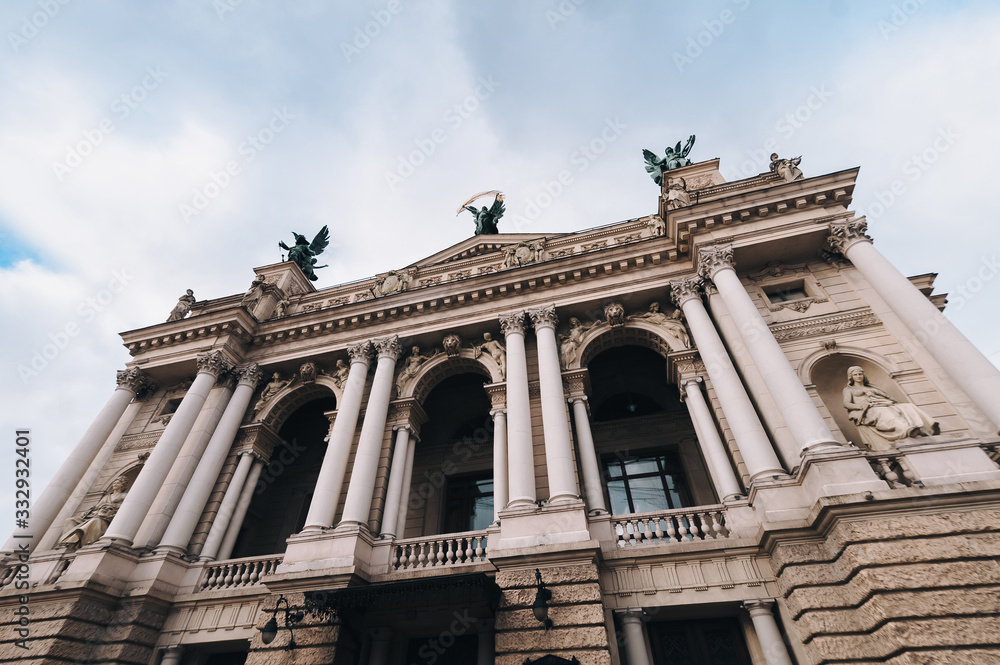 Facade of Lviv theatre of opera and ballet. The central sculpture on roof is Glory, left one is Music, right figure is Comedy and Drama. Copy space.