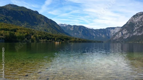 People rafting at Bohinj lake in Slovenian of Triglav National Park. Bohinj Valley of the Julian Alps. Picturesque view, autumn landscape photo