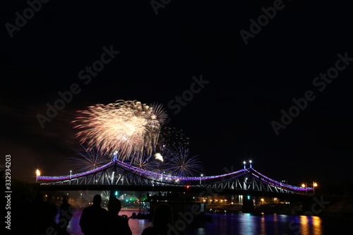 Salute on city day in Tver on the background of the bridge over the Volga river