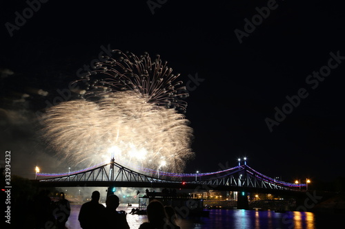 Salute on city day in Tver on the background of the bridge over the Volga river
