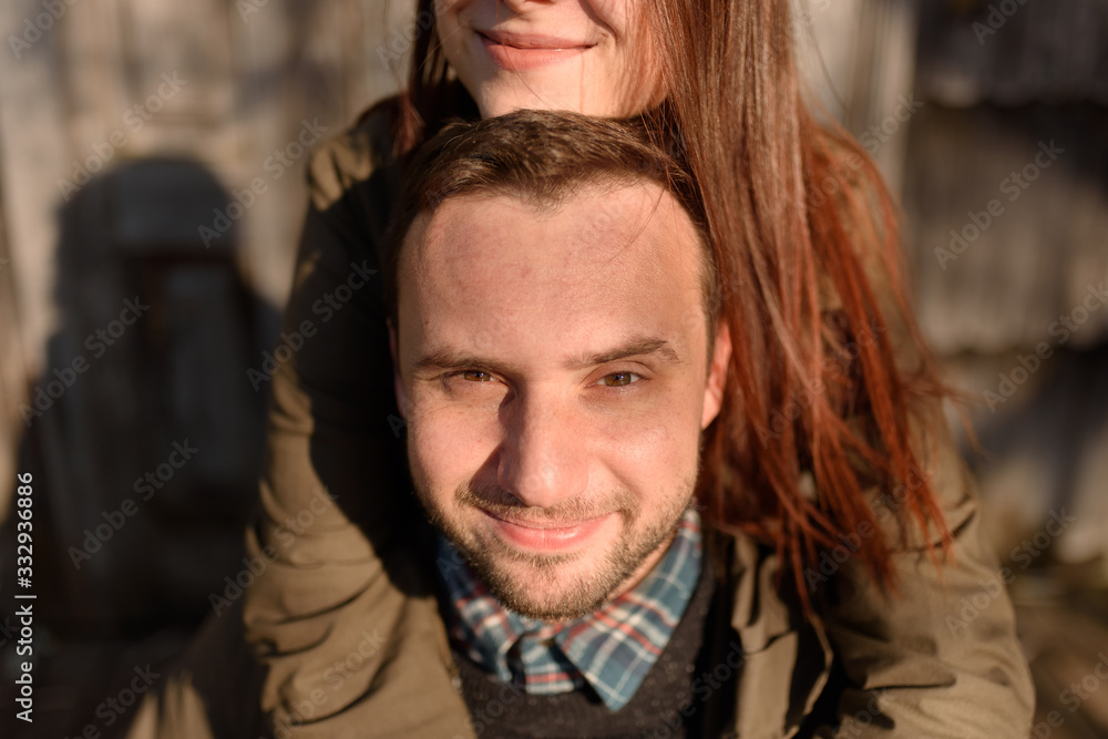 Obraz premium Young fashion couple posing on the street in sunny fall . Creamy autumn sunlight.