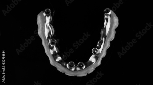 dental prosthesis made of titanium, top view of the fixation point, shot in black and white style