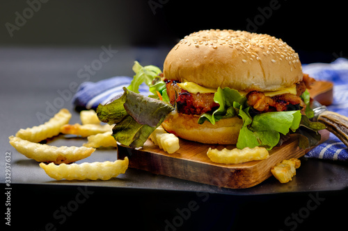 Homemade hamburger with cheese and fresh vegetables.