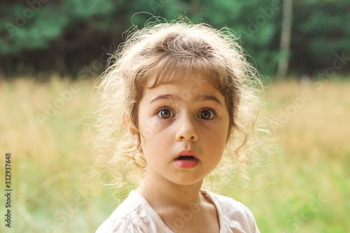 Принти на полотні Close up Portrait of beautiful little Girl  surprised with something at summer d