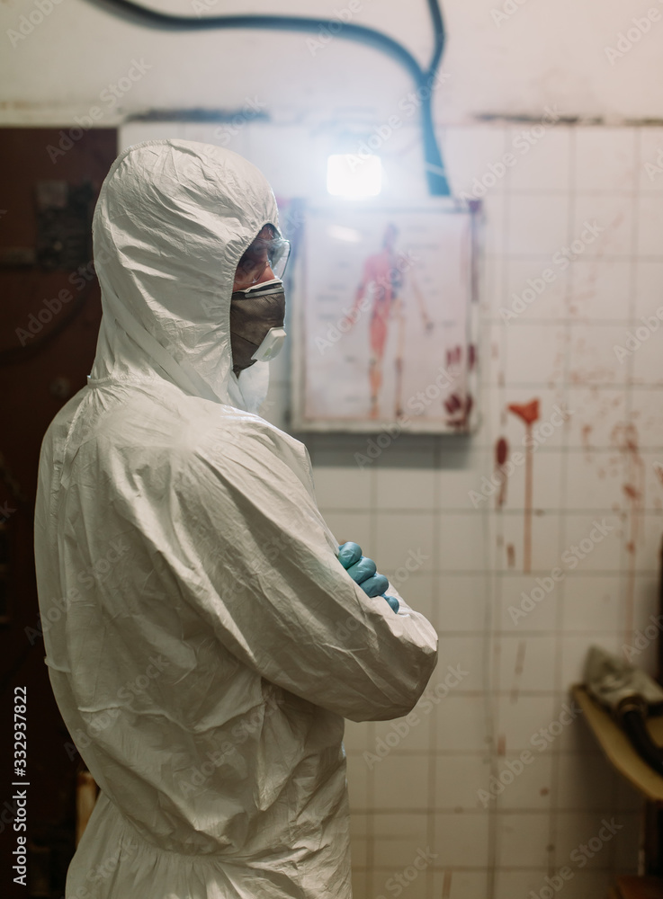 Scientist doctor biologist in hazmat suit and protective respiratory mask working in laboratory  searching vaccine against pandemic Coronavirus COVID-19 to save humanity