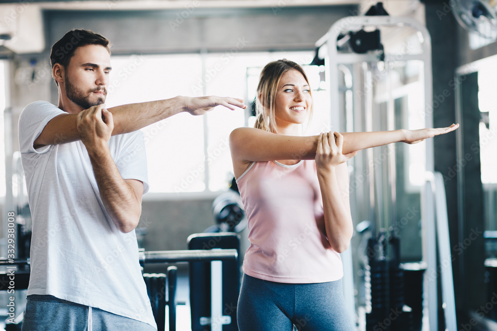 Fototapeta premium Sport couple stretching muscle before sport activity in fitness gym club