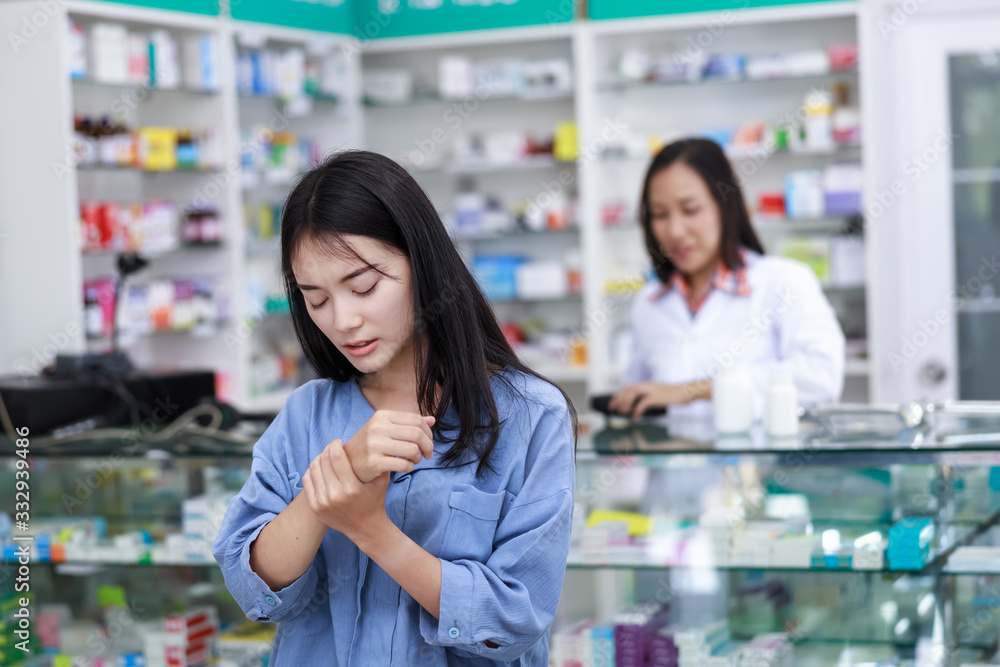 female patient wrist pain in pharmacy