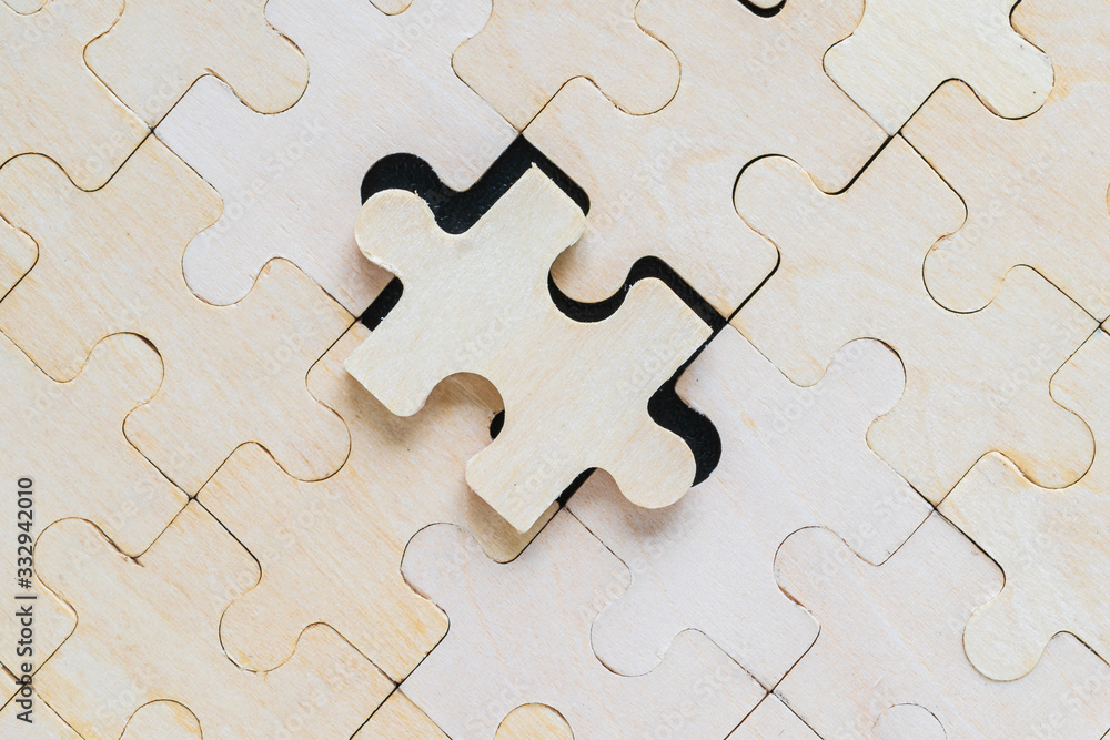 Close up wooden jigsaw puzzle pieces on black background Close up wooden jigsaw puzzle pieces on black background