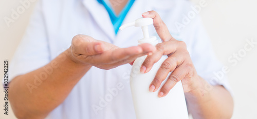 Hand sanitizer alcohol gel rub clean hands hygiene prevention of coronavirus virus outbreak.Doctor holding showing alcohol gel pump bottle, washing hands with alcohol gel or antibacterial sanitizer.