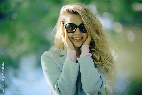 portrait of a european beautiful female model wearing sunglasses / girl outdoors walking, happy cheerful girl wearing glasses