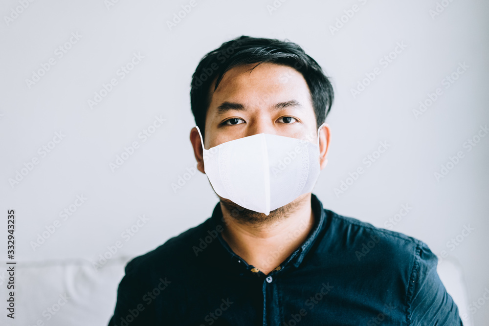 Covid-19 Coronvavirus.Working from home concept.Asian man wearing face mask ready for quarantine 14 day at home.Covid-19 virus outbreak.Working at home.Quarantine asian man.Pandemic virus symptoms. Covid-19 Coronvavirus.Working from home concept.Asian man wearing face mask ready for quarantine 14 day at home.Covid-19 virus outbreak.Working at home.Quarantine asian man.Pandemic virus symptoms.
