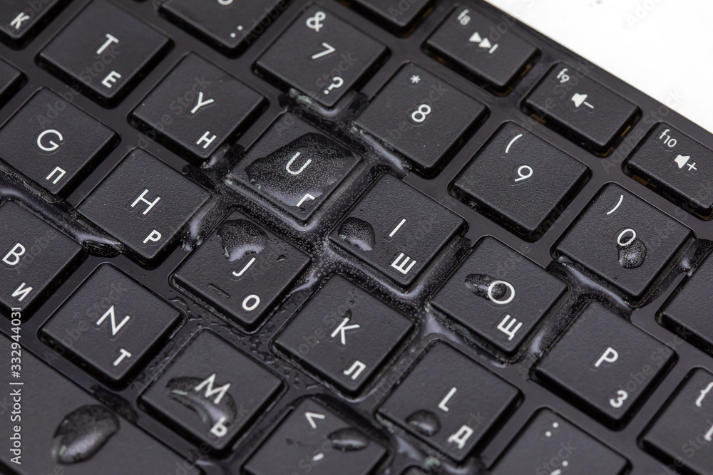 drops of water on a black keyboard