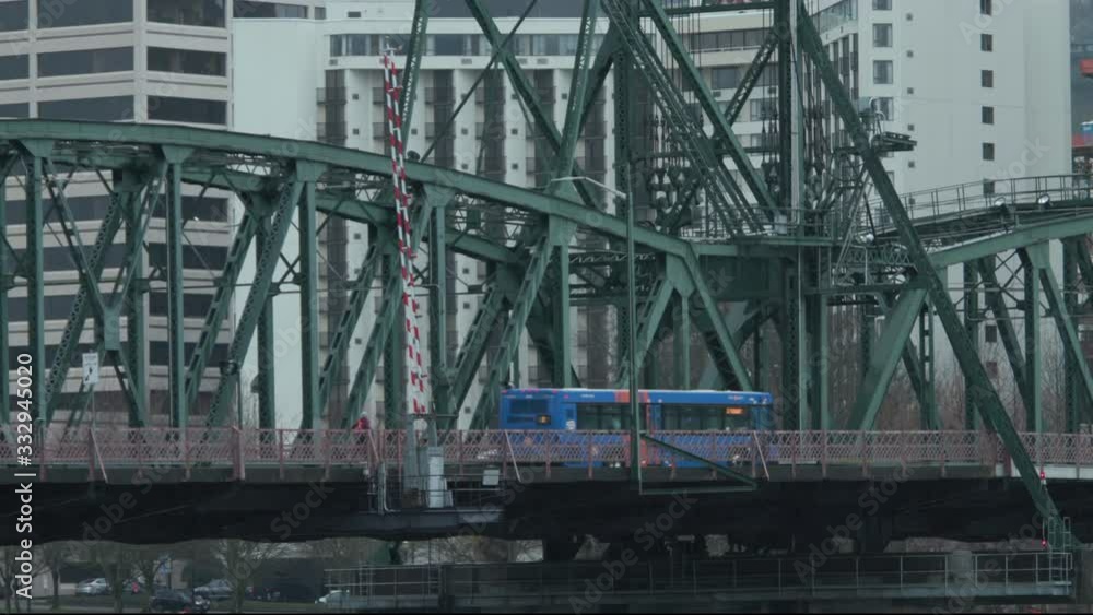City bus and runner with dog crossing bridge in rain City bus and runner with dog crossing bridge in rain