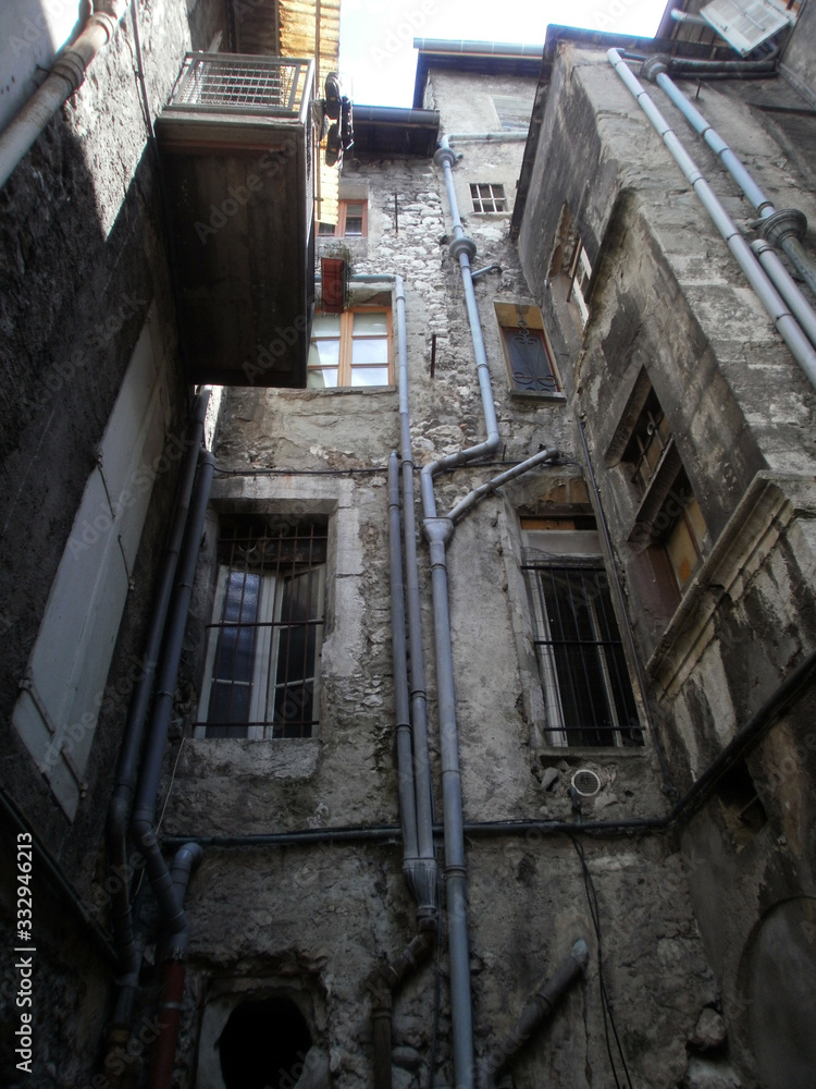 Chambéry, France - August 5th 2011 : Focus on very old facades of a medieval court, in the city center. Chambéry, France - August 5th 2011 : Focus on very old facades of a medieval court, in the city center.