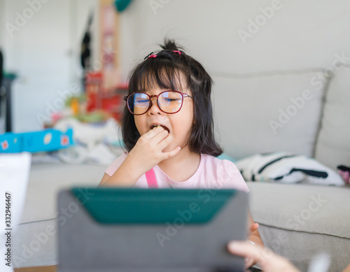 Covid-19 Coronavirus and Learning from home, Home school kid concept.Little asian girl study with online learning and asian mother work from home with laptop.Quarantine and Social distancing concept.