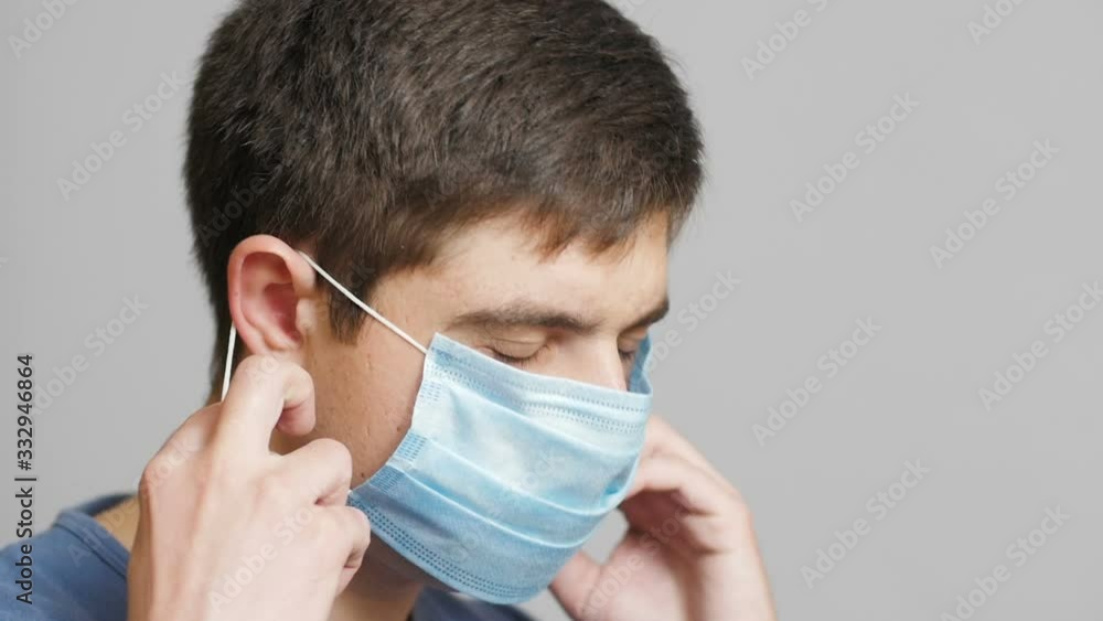exhausted medical worker put on medical and go working hard mask on a gray studio background, concept medicine effort, fight for life exhausted medical worker put on medical and go working hard mask on a gray studio background, concept medicine effort, fight for life