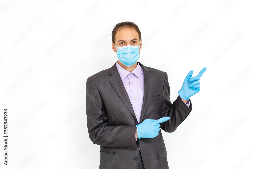 a man with a mask on his face for antivirus individual protection puts on medical sterile gloves - healthcare and medicine concept, prevention tips a man with a mask on his face for antivirus individual protection puts on medical sterile gloves - healthcare and medicine concept, prevention tips