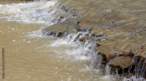 A close view of the flowing water of the brook.