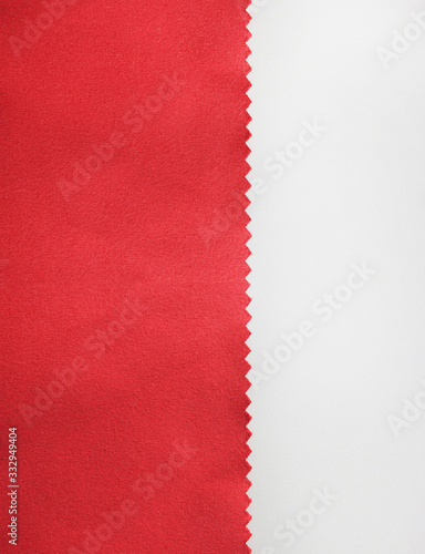 Dark red fabric texture swatch detail isolated on white background. Piece of smooth burgundy colour velvet material, seamless natural cloth fragment, unprinted blank copy space