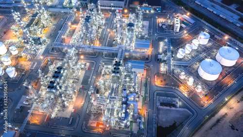 Large industrial estates of oil and gas refinery, Aerial view of industry plants, oil storage tanks and pipeline at night.