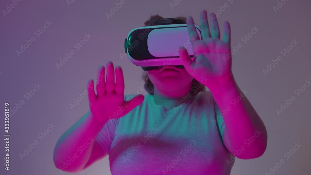 Young woman in 3d goggles playing game, virtual reality, entertainment Young woman in 3d goggles playing game, virtual reality, entertainment