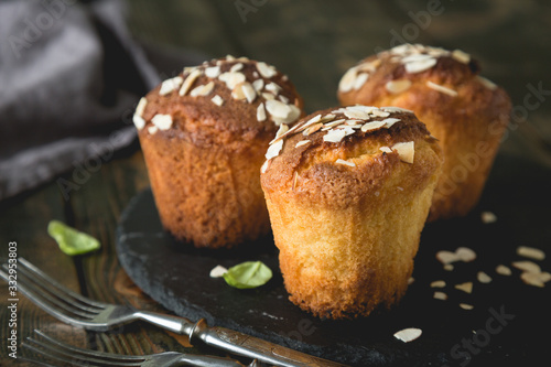 Fresh muffins with marzipan and almonds