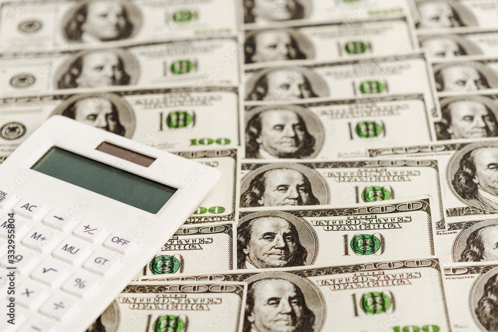 Calculator on dollar banknotes, coronavirus economic crisis concept