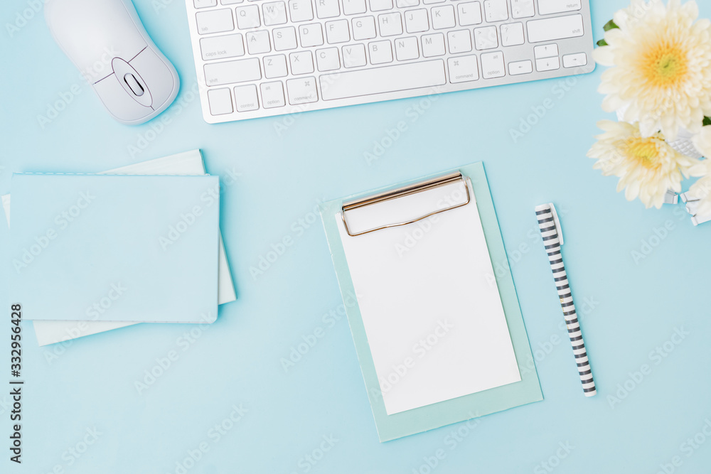 Flat lay blogger or freelancer workspace with a keyboard, flowers in a vase, office supplies on a color background Flat lay blogger or freelancer workspace with a keyboard, flowers in a vase, office supplies on a color background
