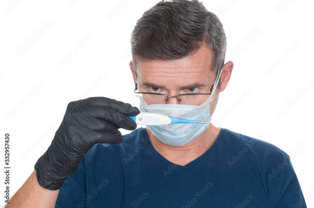 Adult man wearing in medical protect mask with thermometer on white background. Front focus Adult man wearing in medical protect mask with thermometer on white background. Front focus