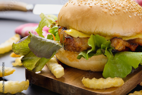 Homemade hamburger with cheese and fresh vegetables.