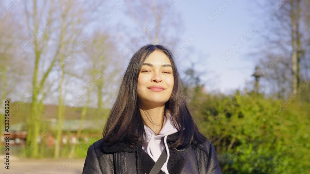 Young confident Women smiling into the camera while walking Young confident Women smiling into the camera while walking