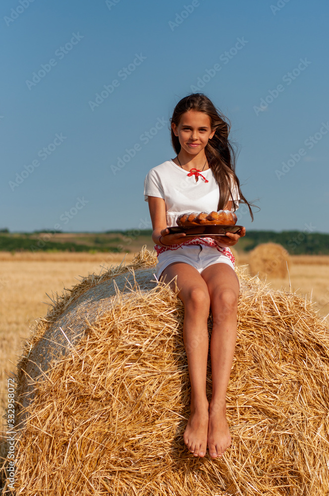 vertical portrait of a slim teenage girl with beautiful long hair and pastries in her hands vertical portrait of a slim teenage girl with beautiful long hair and pastries in her hands