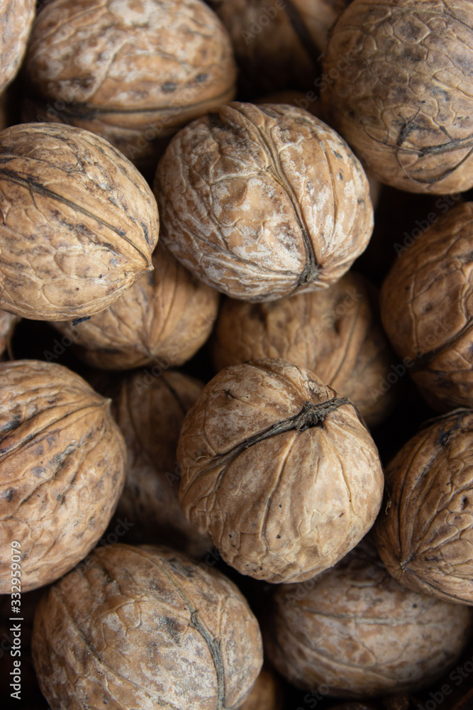 Walnuts in shell .Inshell walnuts close-up. Brown walnuts. Walnuts in shell .Inshell walnuts close-up. Brown walnuts.