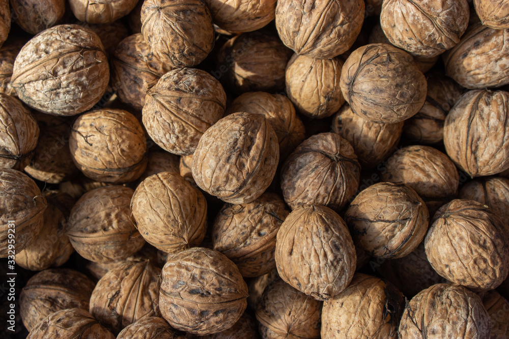 Walnuts in shell .Inshell walnuts close-up. Brown walnuts. Walnuts in shell .Inshell walnuts close-up. Brown walnuts.