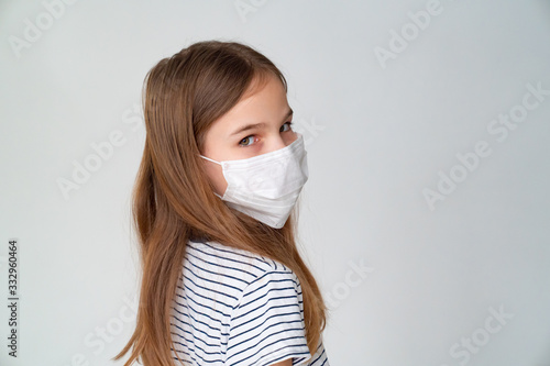 teenager girl in medical mask on white background