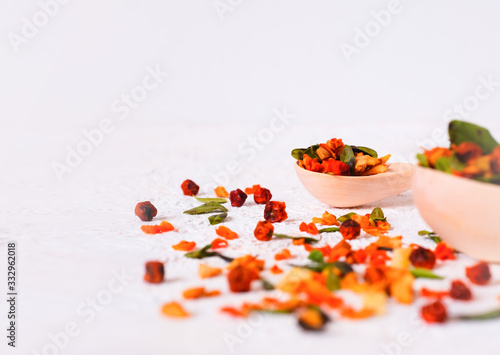 Super Food. Berry fruit drink In a wooden spoon on a white background. . Recovery after illness, virus. Immunity strengthening. Lingonberry, sea buckthorn, cranberry, lingonberry leaf, carrot, pineapp photo